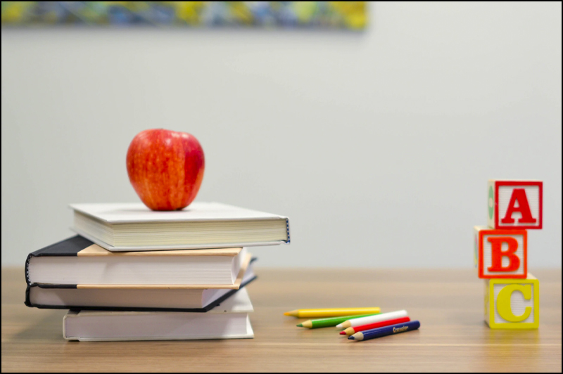 Image of apple, books, pencils, blocks