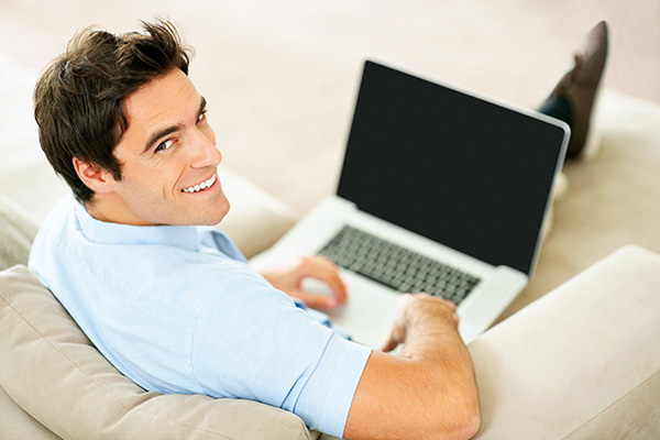 Man sitting on the couch with a laptop