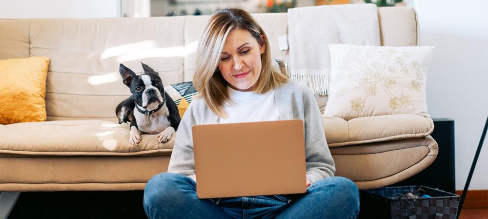 Woman on computer with dog