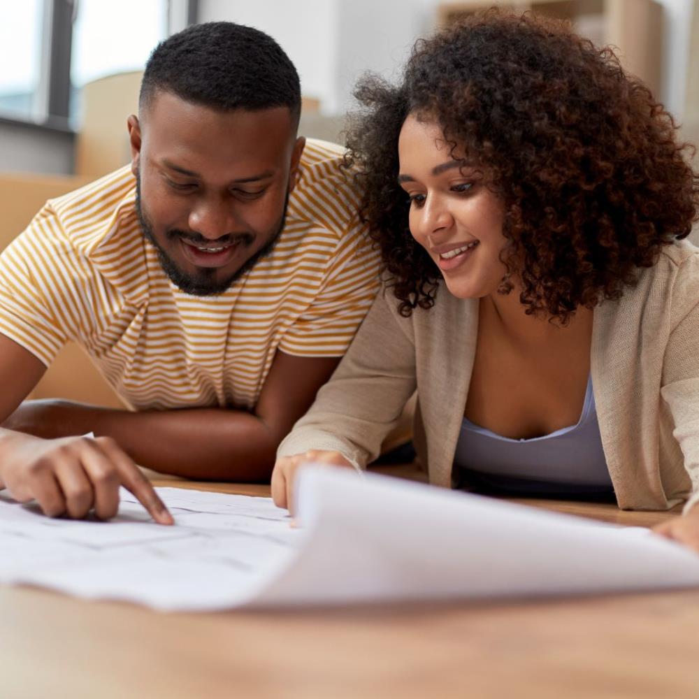 Couple looking at construction blueprint