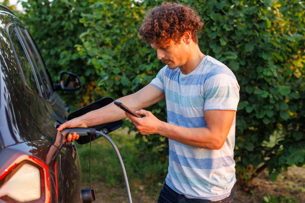 Man Charging His Electric Vehicle