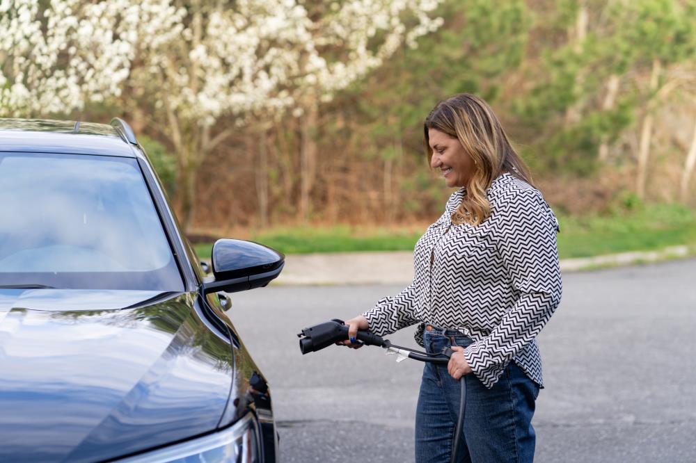 Woman Charging an Electric Vehicle