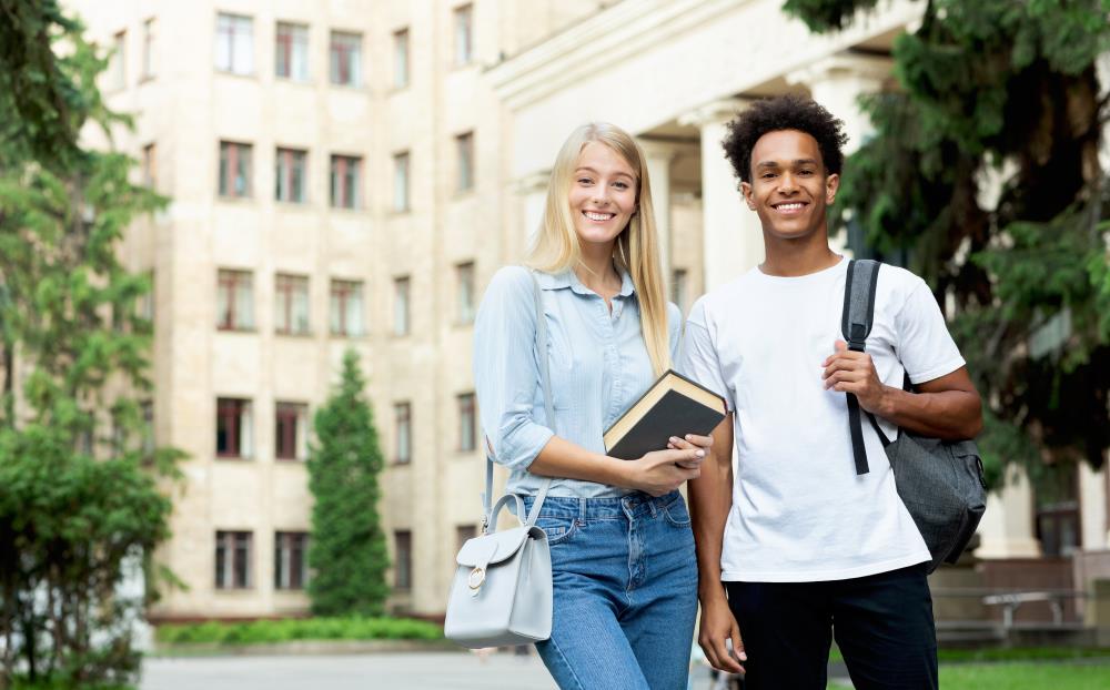 Female and Male Student posing on College Campus