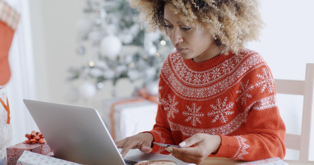 Woman with a card and a laptop