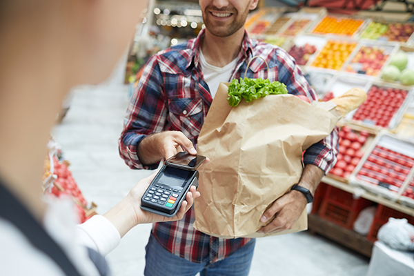 Man making grocery purchase with digital wallet